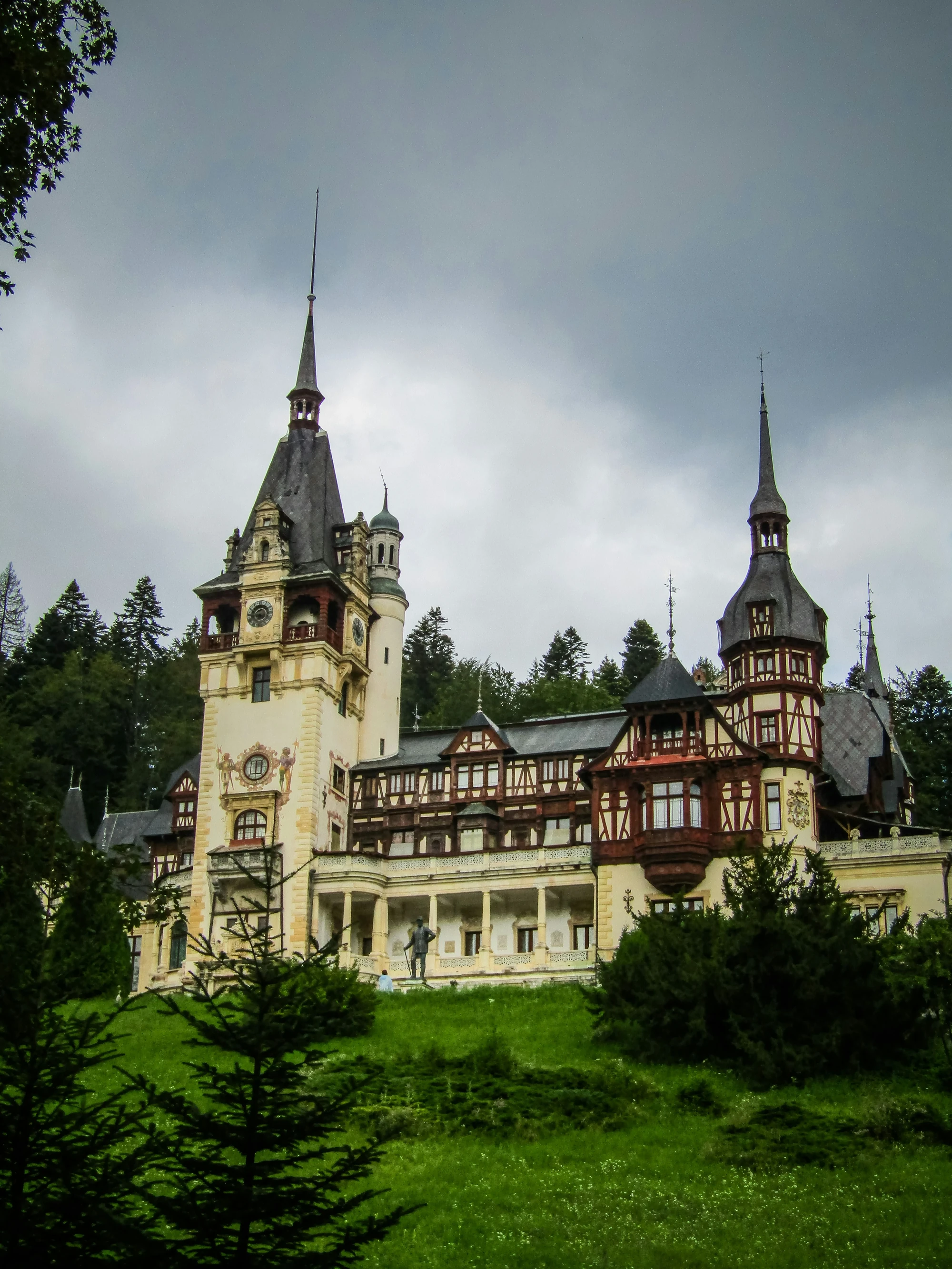 Peleș Castle in Sinaia surrounded by Carpathian forest